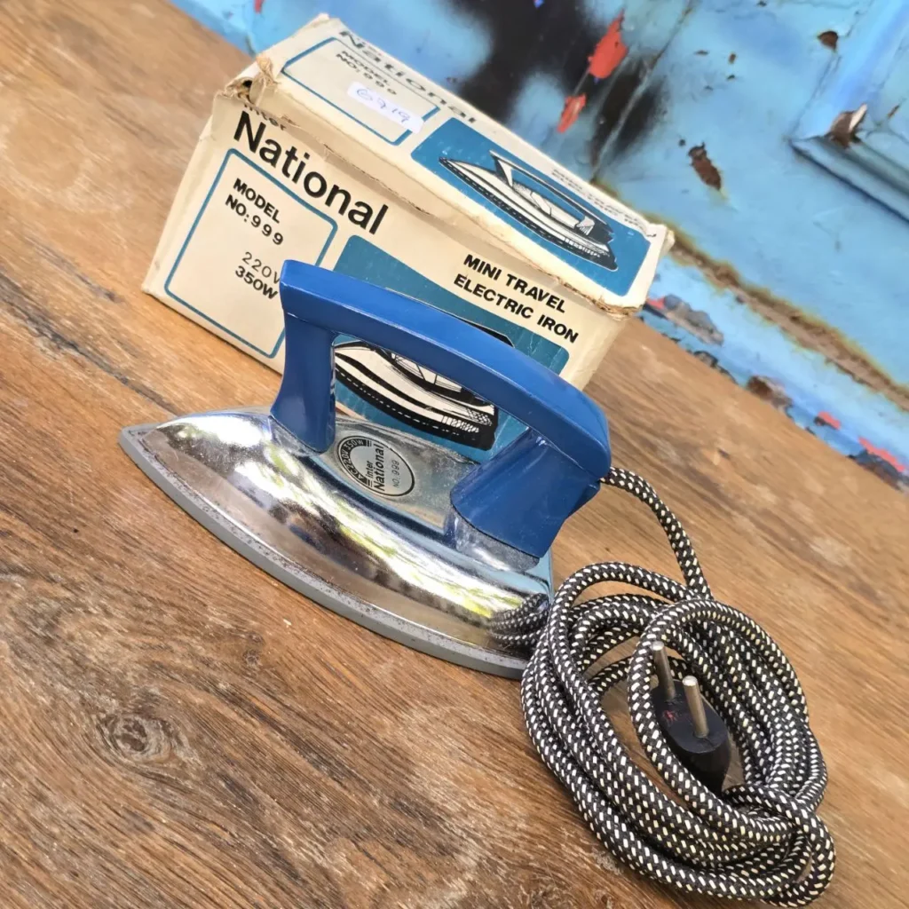 Plancha eléctrica de viaje mini National Modelo 999 con mango azul, base cromada y caja original. by Remates Narvaja