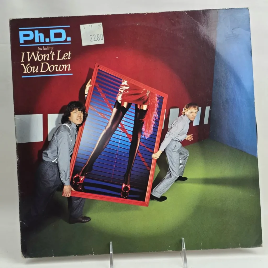 Portada del álbum Ph.D. 'I Won't Let You Down' con dos hombres llevando un espejo que refleja piernas de mujer con medias by Remates Narvaja