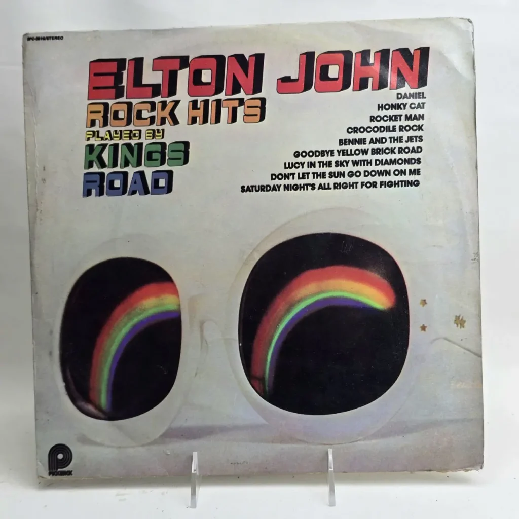 Cubierta de álbum de vinilo "Elton John Rock Hits Played by Kings Road" con gafas blancas y arcoíris en los cristales. by Remates Narvaja