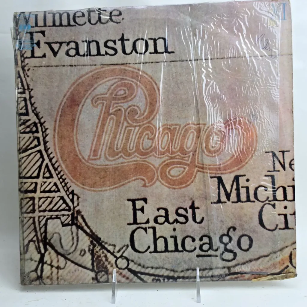 Portada de álbum de vinilo de Chicago sellada en plástico, con el logo de la banda y nombres de ciudades como Wilmette, Evanston y East by Remates Narvaja