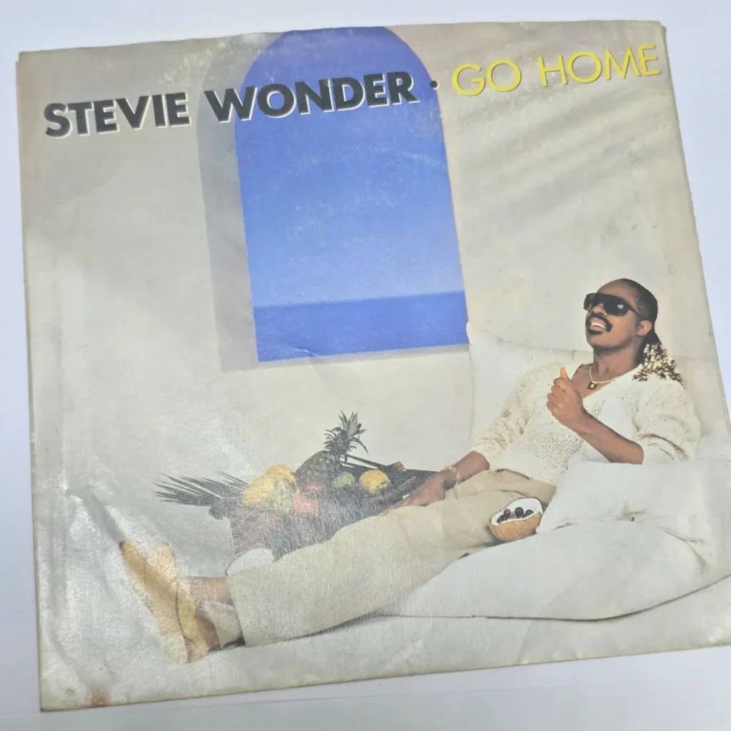 Portada del single vintage de Stevie Wonder "Go Home", con el artista recostado y sonriendo. by Remates Narvaja