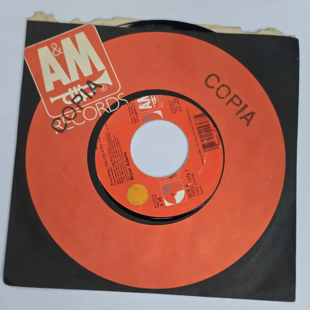 Disco de vinilo 45 RPM de Bryan Adams "(Everything I Do) I Do It For You" con etiqueta naranja de A&M Records y by Remates Narvaja