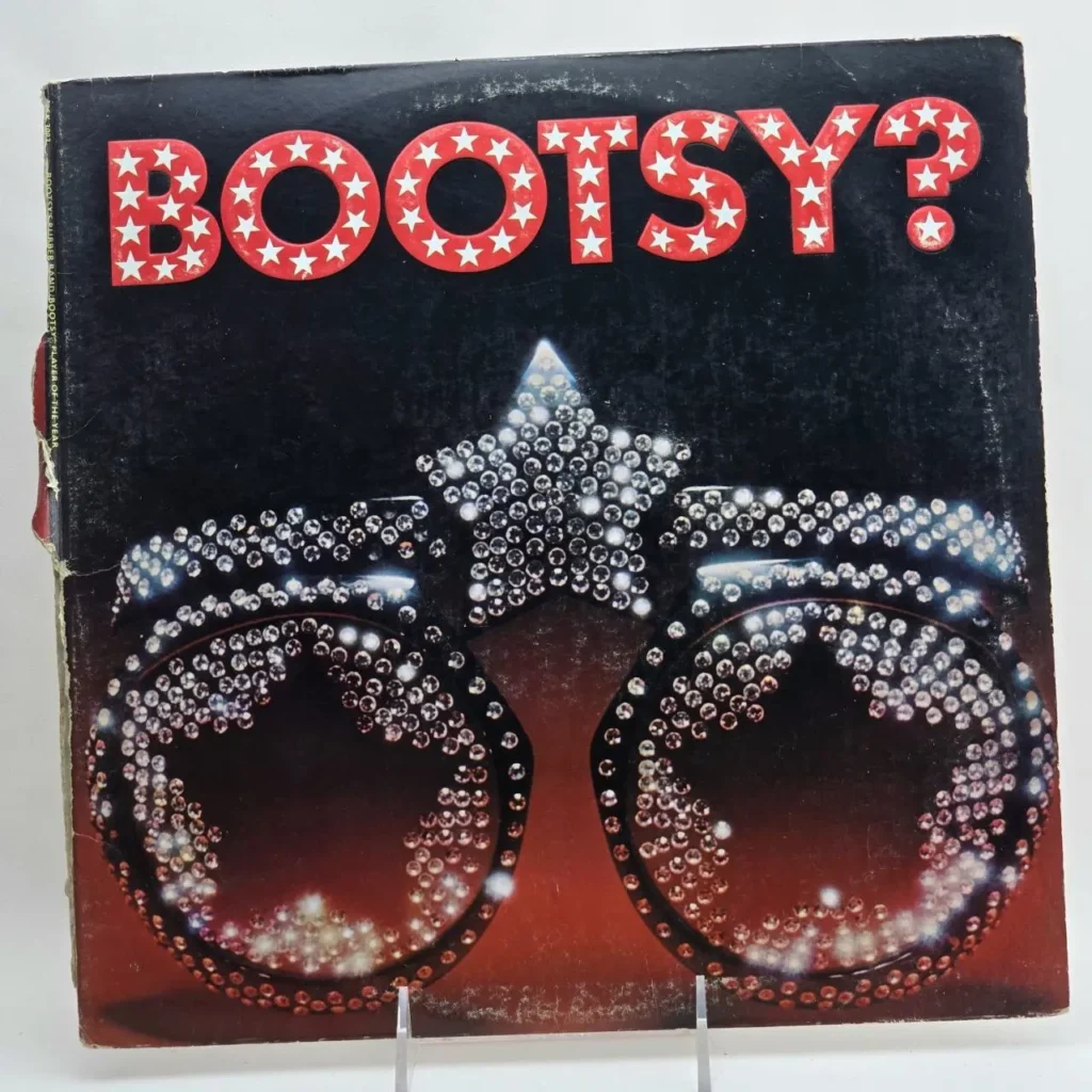 Portada del álbum "Bootsy?" de Bootsy's Rubber Band, con gafas de sol de estrella adornadas con diamantes de imitación. by Remates Narvaja