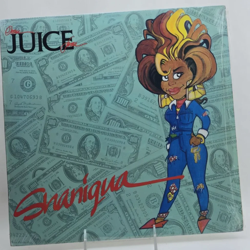 Portada del álbum Original Juice Shaniqua con caricatura de mujer sobre fondo de billetes de dólar. by Remates Narvaja