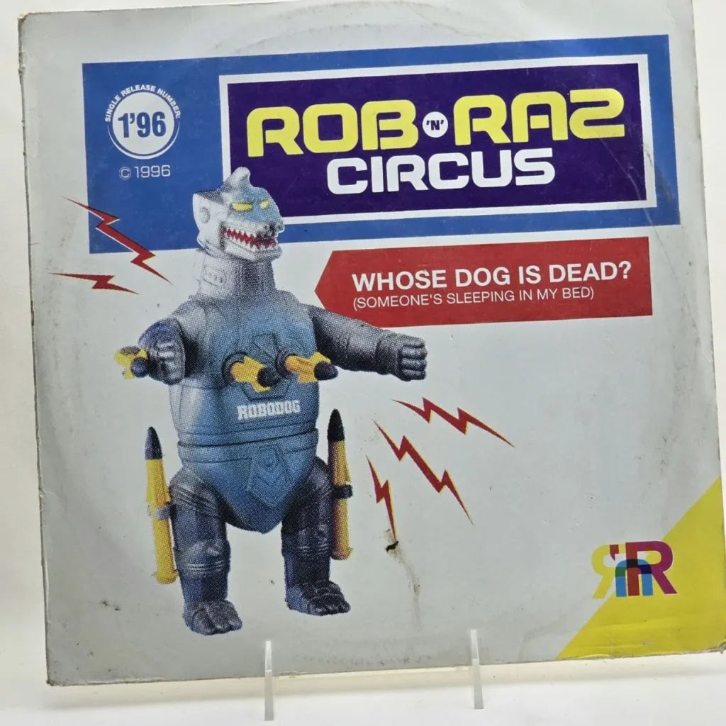 Rob 'n' Raz Circus - Whose Dog Is Dead? (Someone's Sleeping In My Bed) 1996 single record cover with robot by Remates Narvaja