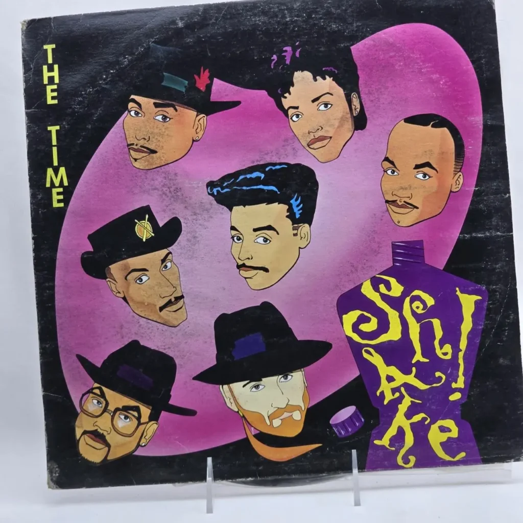 Portada de vinilo de The Time "Shake!" con cabezas de personajes de dibujos animados. by Remates Narvaja