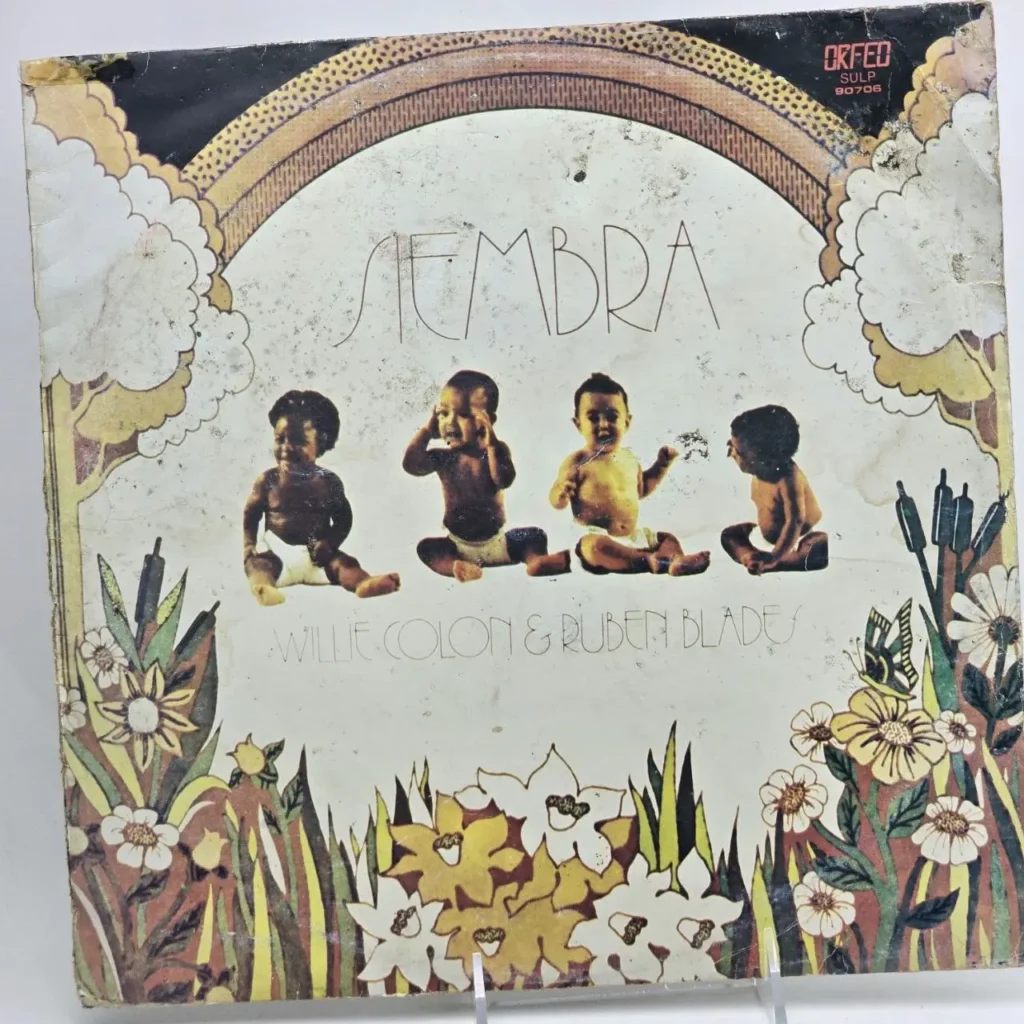 Portada del álbum Siembra de Willie Colón y Rubén Blades con cuatro bebés, un arcoíris y flores. by Remates Narvaja