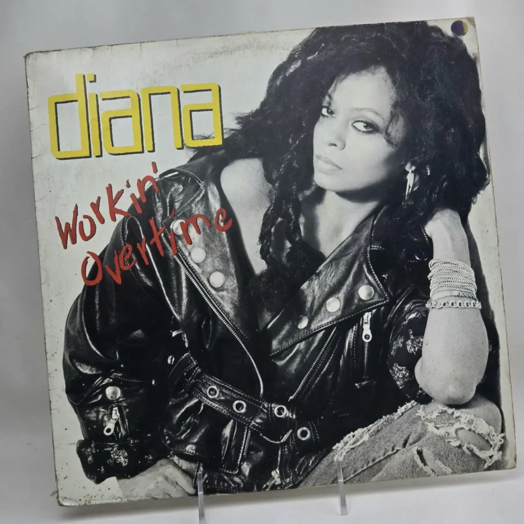 Portada del álbum "Workin' Overtime" de Diana Ross, con ella en chaqueta de cuero y jeans rotos. by Remates Narvaja
