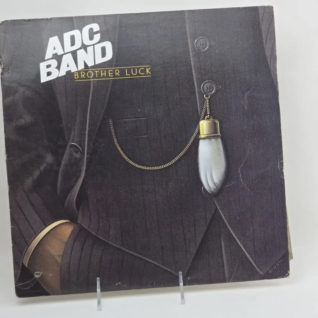Portada de álbum ADC BAND Brother Luck con traje a rayas y pata de conejo. by Remates Narvaja