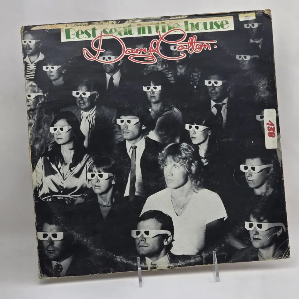 Daryl Cotton Best Seat in the House album cover featuring a crowd wearing 3D glasses in black and white. by Remates Narvaja