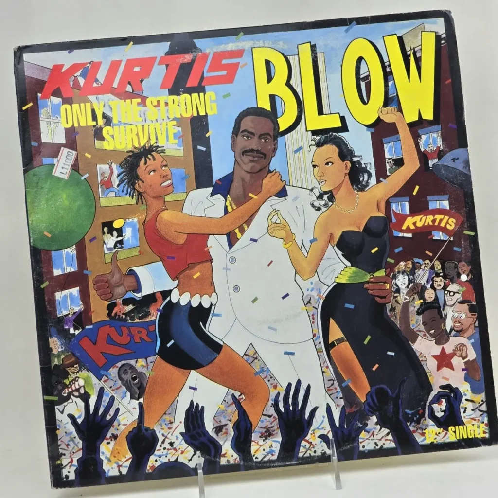Portada del álbum de Kurtis Blow "Blow" (Only The Strong Survive) con ilustración de un hombre y dos mujeres celebrando en una ciudad. by Remates Narvaja