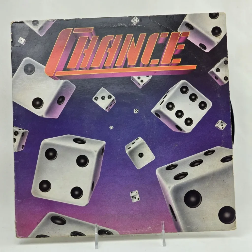 Portada de álbum Chance con dados blancos dispersos sobre fondo púrpura. by Remates Narvaja