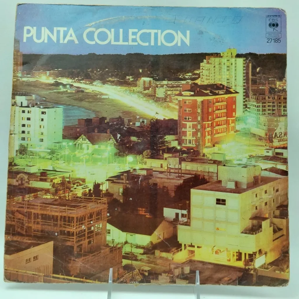 Portada de álbum "Punta Collection" con vista nocturna de ciudad costera. by Remates Narvaja