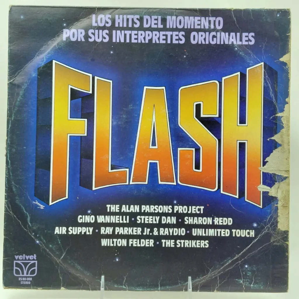 Portada de álbum "Flash" con el texto "Los Hits del Momento" y artistas como The Alan Parsons Project, Steely Dan, Air by Remates Narvaja