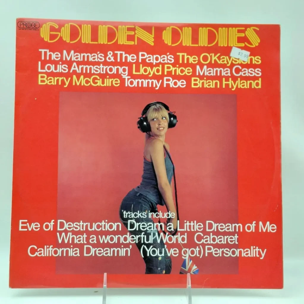 Portada de álbum "Golden Oldies" en rojo con una mujer rubia con auriculares, listando artistas como The Mamas & The Papas y Louis Armstrong by Remates Narvaja