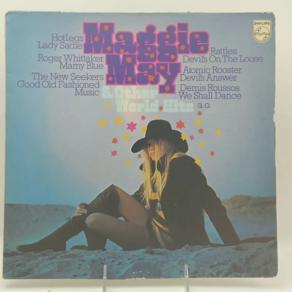 Portada de álbum de vinilo "Maggie May & Other World Hits" con una mujer rubia con sombrero negro y botas sentada en un paisaje aren by Remates Narvaja
