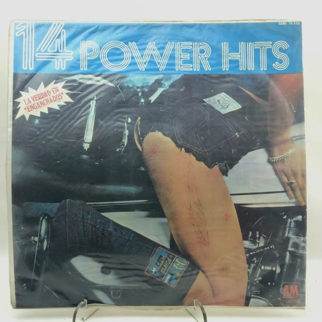 Portada de álbum de vinilo "14 Power Hits" con una persona en shorts de mezclilla y la frase "La Verdad en Enganch by Remates Narvaja