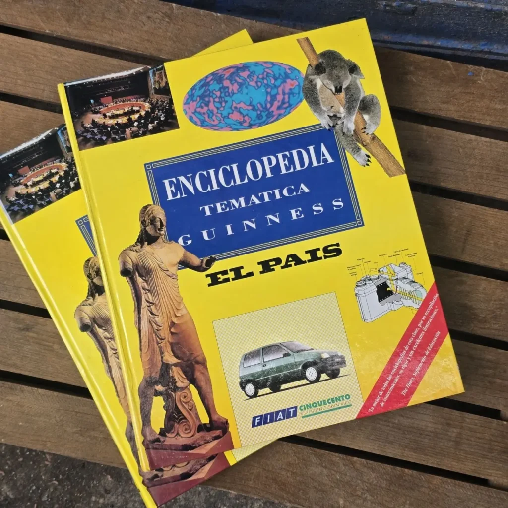 Dos enciclopedias amarillas 'Enciclopedia Temática Guinness El País' con imágenes de un koala, una estatua clásica y un coche Fiat by Remates Narvaja