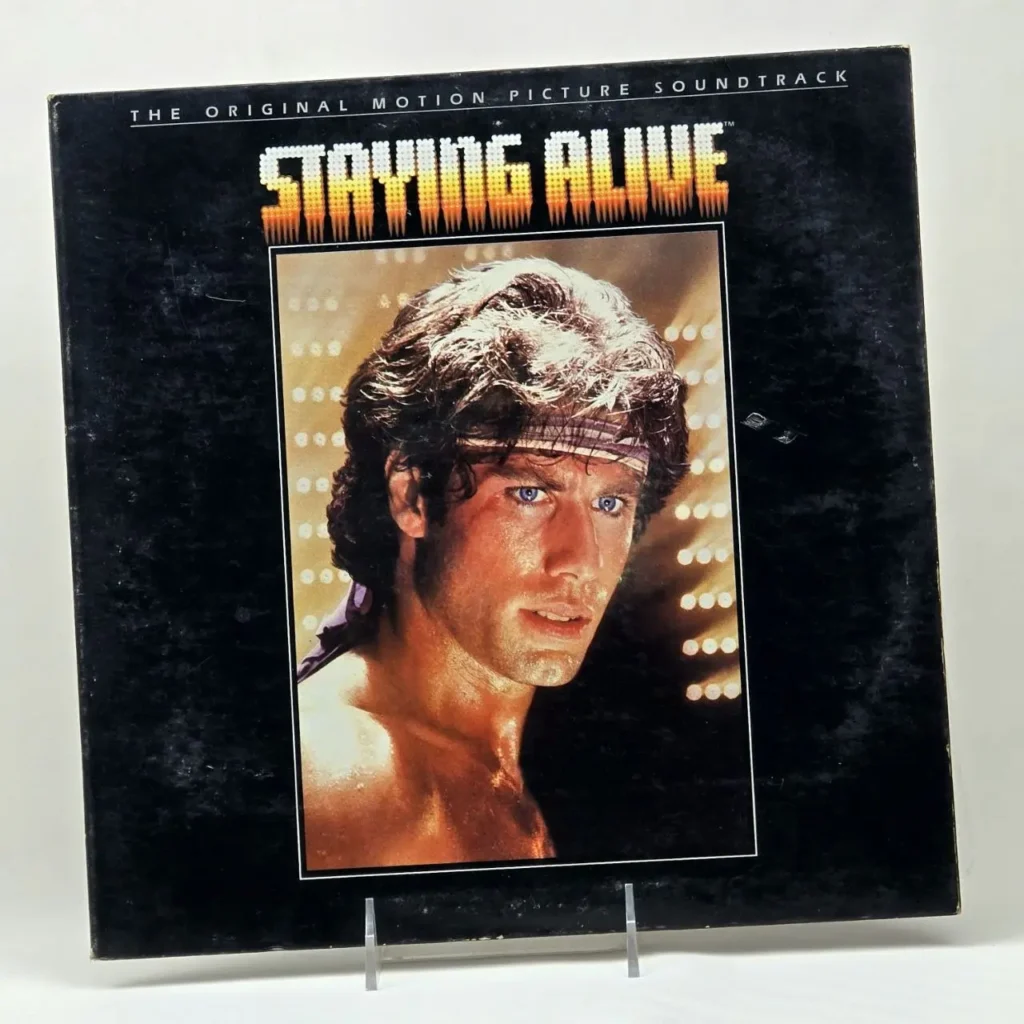 Portada del álbum Staying Alive con John Travolta. by Remates Narvaja