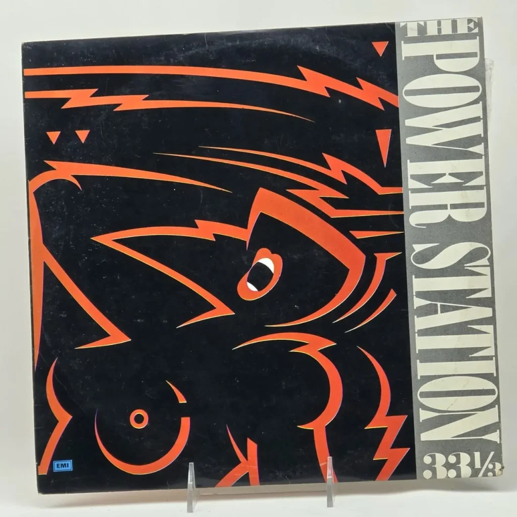 Portada de vinilo The Power Station con diseño abstracto naranja de relámpagos sobre fondo negro, texto 33 1/3. by Remates Narvaja