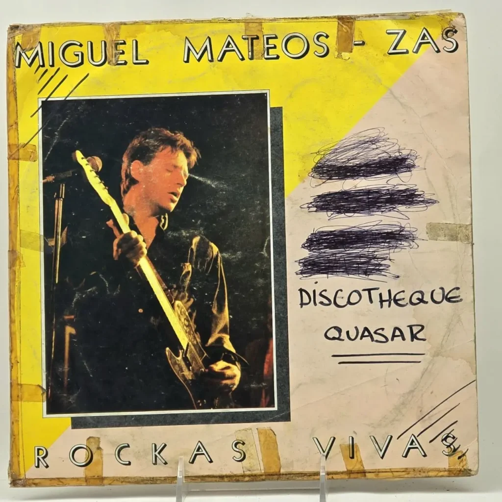 Portada de vinilo de Miguel Mateos - Zas "Rockas Vivas" con el músico tocando guitarra eléctrica y el título "Discotheque Quasar by Remates Narvaja