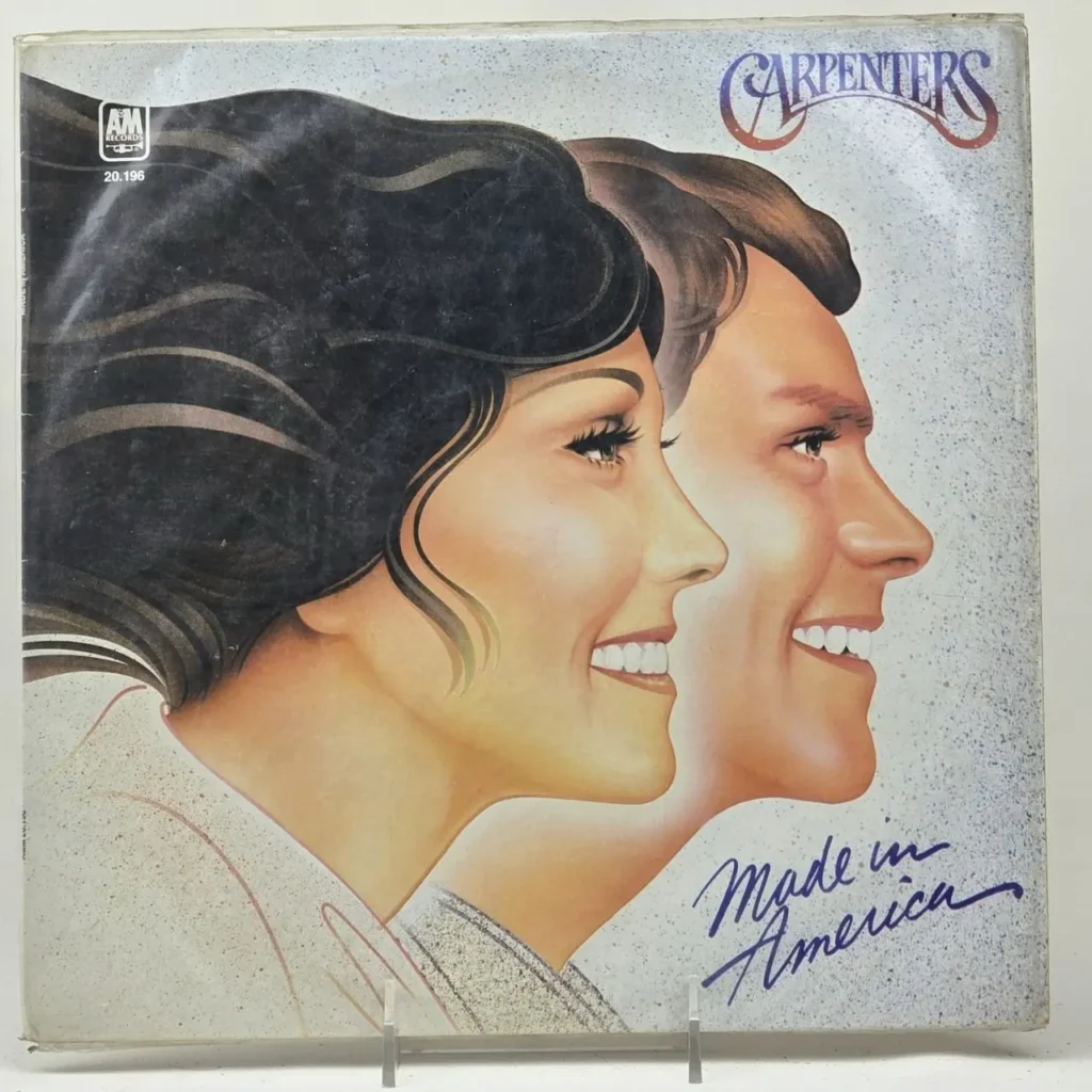 Portada del álbum Made in America de Carpenters con ilustraciones de perfiles sonrientes. by Remates Narvaja