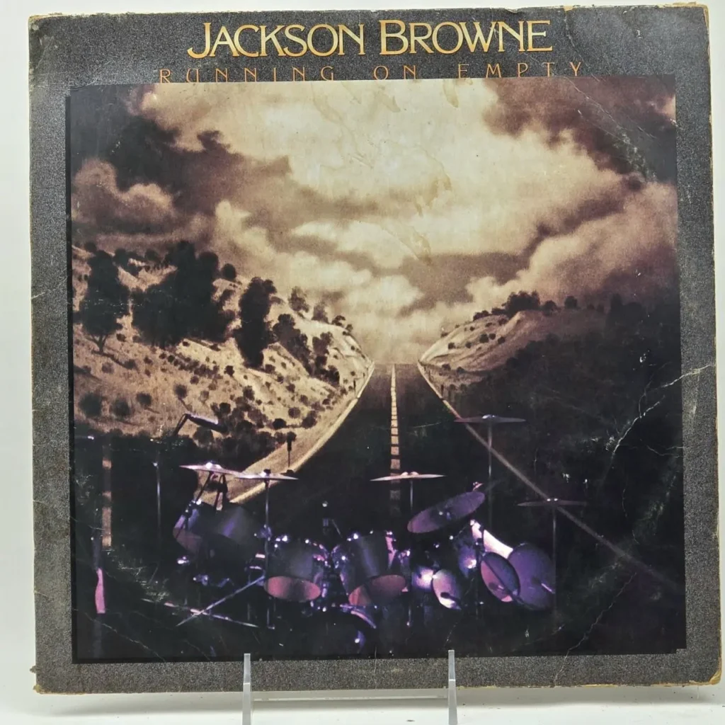 Jackson Browne Running On Empty album cover con batería en una carretera. by Remates Narvaja
