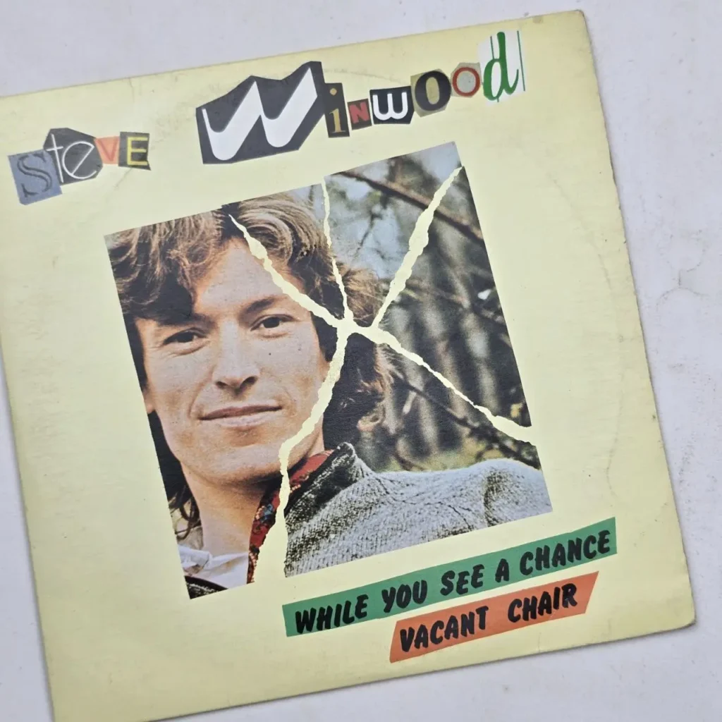 Portada de single de Steve Winwood con su rostro rasgado y letras de collage para 'While You See a Chance' y 'Vacant Chair'. by Remates Narvaja