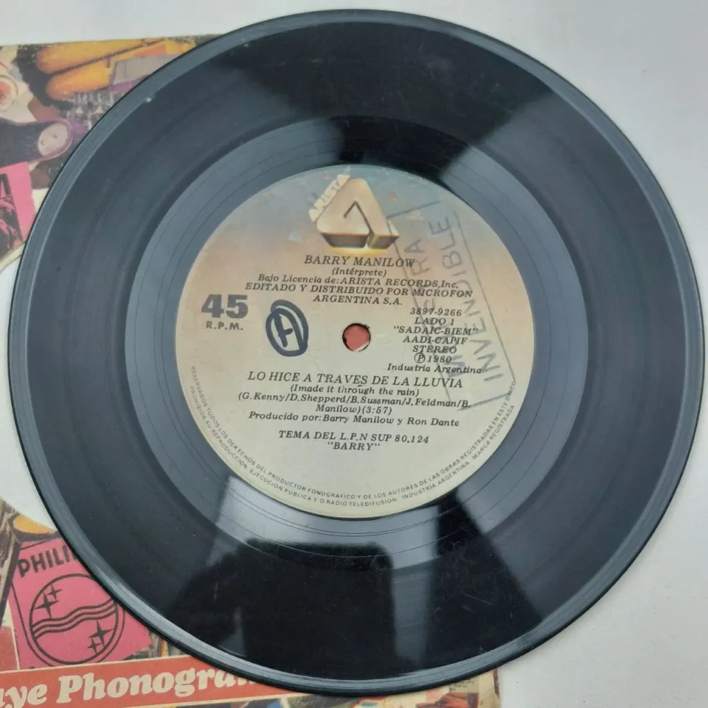 Disco de vinilo 45 RPM de Barry Manilow "Lo Hice A Traves De La Lluvia" (I Made It Through The Rain) de 1980, sello Arista, edición argentina. by Remates Narvaja