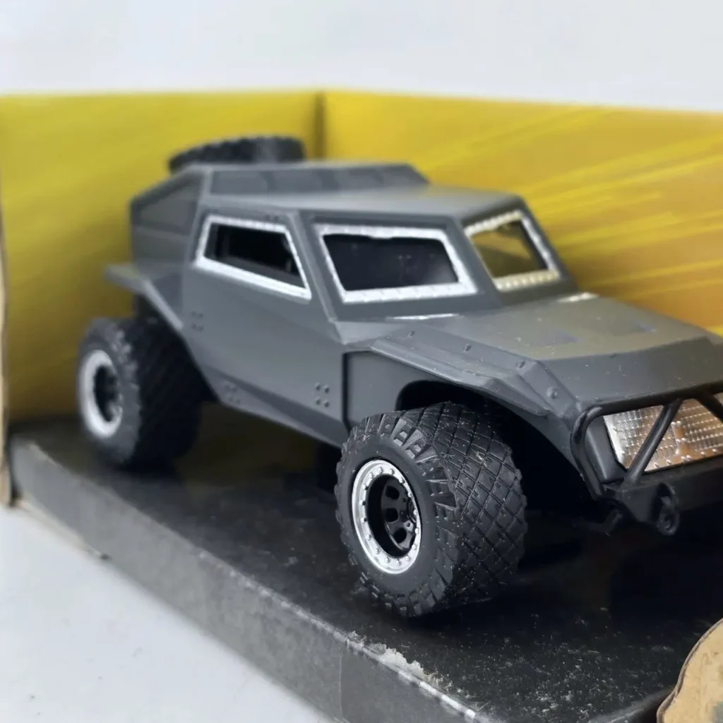 Vehículo todoterreno blindado de juguete gris.** (Grey armored off-road toy vehicle.) This is concise, descriptive, and includes relevant keywords for by Remates Narvaja