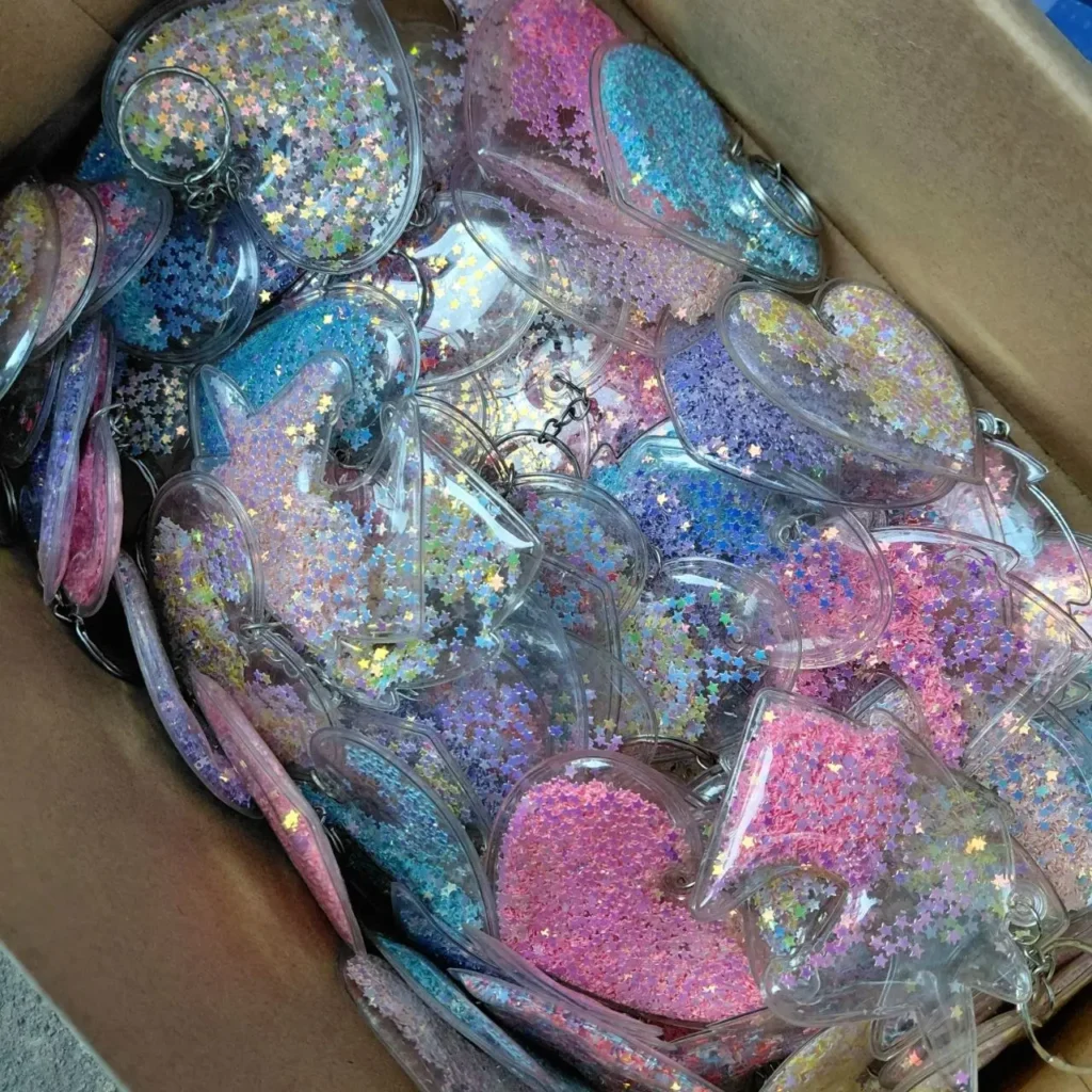 Surtido de llaveros de corazón de plástico transparente con brillo de estrellas en colores pastel, en una caja. by Remates Narvaja