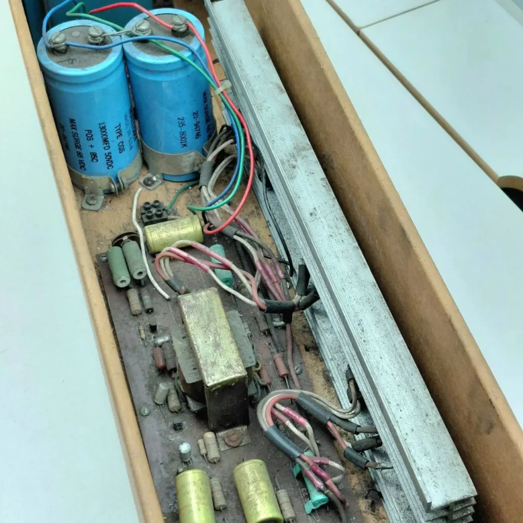 Interior de equipo electrónico vintage con condensadores, transformador y cableado. by Remates Narvaja