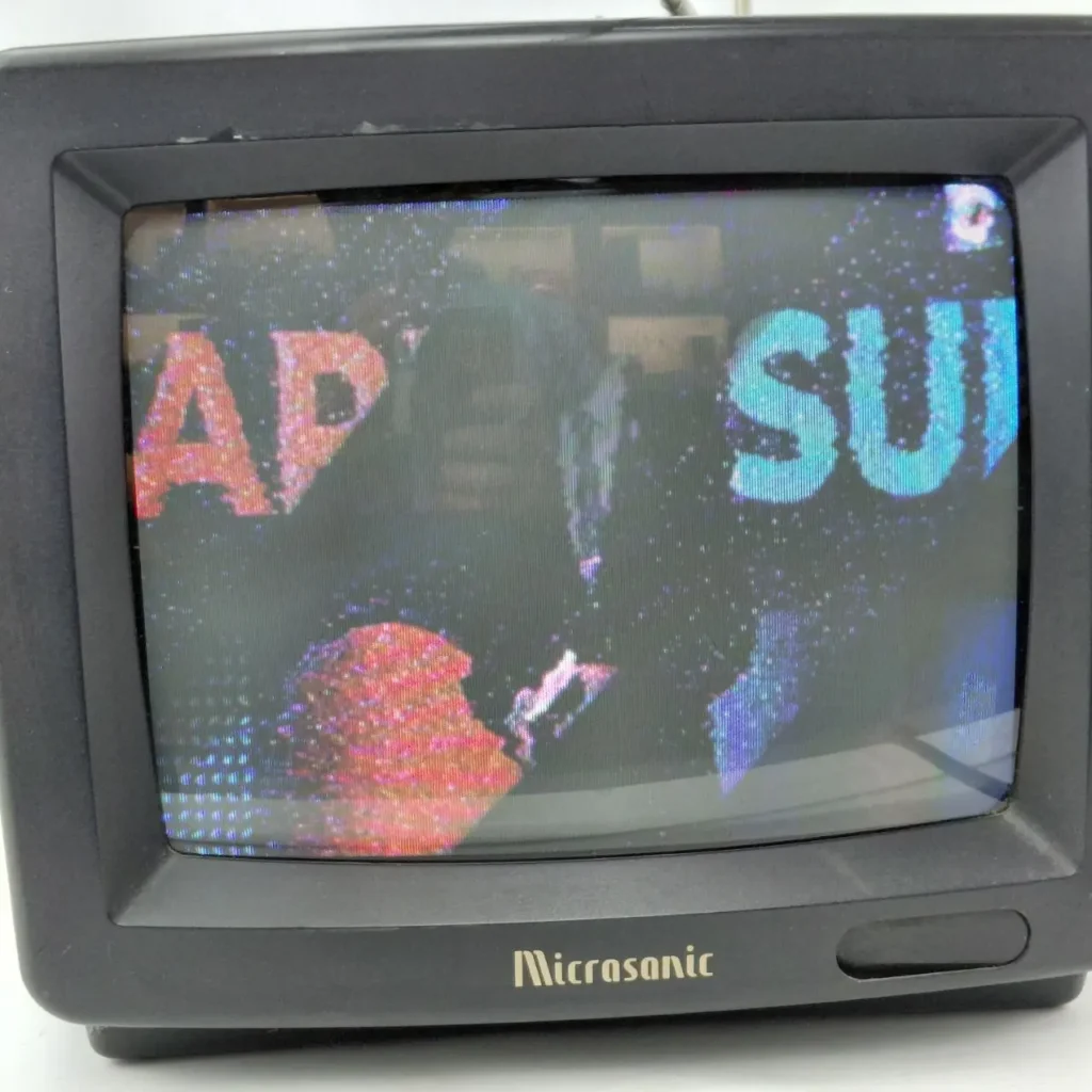 Televisor vintage Micrasonic negro con pantalla con estática mostrando letras "AP" y "SU". by Remates Narvaja