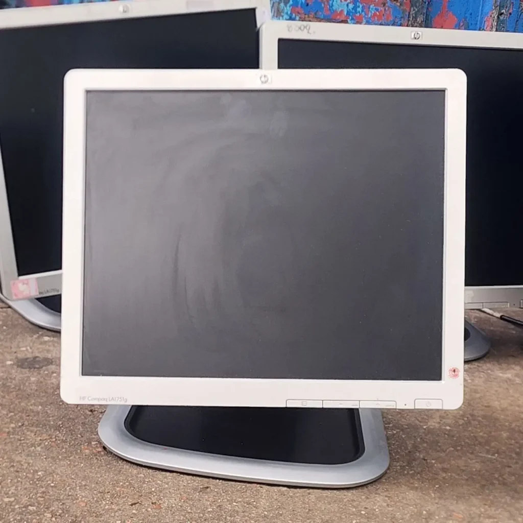 Monitor HP Compaq LA1751g blanco usado, con otros monitores en el fondo. by Remates Narvaja